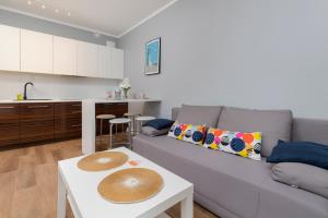 a living room with a couch and a table at Gdańsk Krasickiego Apartments by the Beach by Renters in Gdańsk