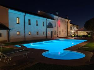 a swimming pool in front of a building at night at Villa Dello Spino in Concordia sulla Secchia