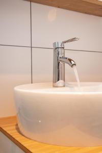 a white sink with a faucet on a counter at boardinghouse44 in Georgsmarienhütte