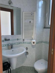a bathroom with a sink and a toilet at affittacamere san pietro resort in Rome