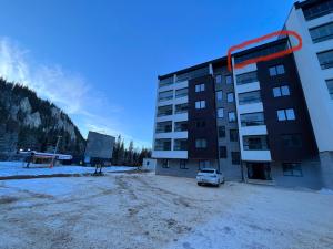 a parking lot in front of a building at Staza Ski Apartment in Jahorina