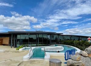 a pool with a slide in front of a building at Duplex Climatisé 65m2 refait à neuf in Gruissan
