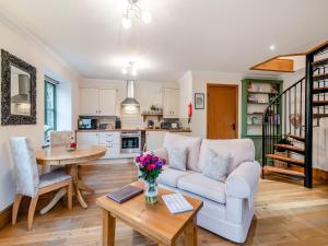 a living room with a couch and a table at Mollys Den in Grimston