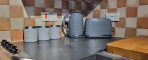 three coffee mugs sitting on top of a counter at Cosy Stays Daybrook in Nottingham