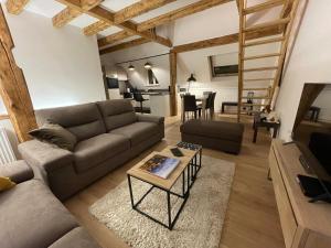 ein Wohnzimmer mit einem Sofa und einem Tisch in der Unterkunft Le 6B in Hoenheim