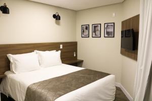 Un pat sau paturi într-o cameră la Pousada Augusta Canela