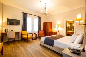 a hotel room with a large bed and a desk at Zanike hotel in Trabzon