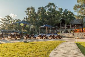 a group of benches and umbrellas in a park at Carmelo Resort & Spa in Carmelo