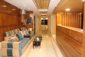 a lobby with a couch and a table at The Blue Moon Hotel in Chittagong
