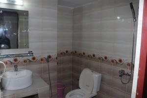 a bathroom with a toilet and a sink at The Blue Moon Hotel in Chittagong