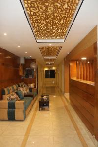 a living room with a couch and a table at The Blue Moon Hotel in Chittagong