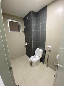 a bathroom with a toilet and a sink at SKF Homestay in Puchong