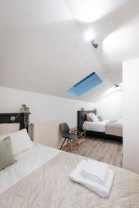 a bedroom with two beds and a blue ceiling at Les Loges du Léman in Crozet