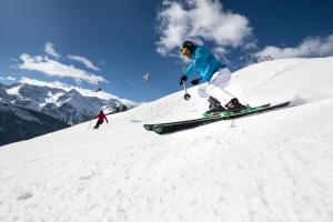 a person is skiing down a snow covered slope at Hotel Finkenbergerhof in Finkenberg