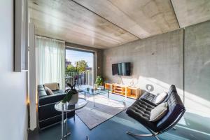 a living room with two couches and a tv at L'INOX in Toulouse