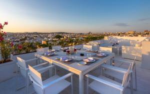 a table and chairs on a balcony with a view at Dar Dorra in Tunis