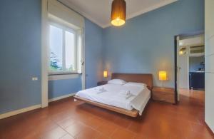 ein Schlafzimmer mit einem großen Bett und einem Fenster in der Unterkunft Design Loft in Villa Magnolia in Lierna