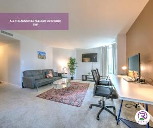 an apartment living room with a couch and a desk at Renu At Back Bay in Boston