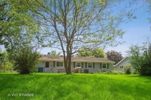 a house with a tree in a grassy yard at Pet Friendly Ranch Home 30 mins from O'Hare in Schaumburg