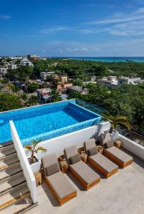 a swimming pool on the roof of a house at Balkon Boutique Hotel in Playa del Carmen
