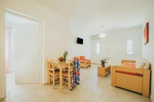 a living room with a table and a dining room at Sunrise Studios in Stelida