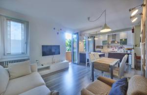 a living room and kitchen with a couch and a table at Nicola Flat in Lierna