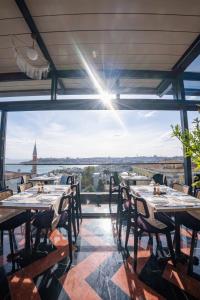 a restaurant with tables and a view of the city at Fragments Hotel in Istanbul