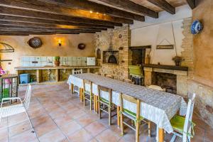 a large kitchen with a long table and chairs at El Ranchito in Paguera