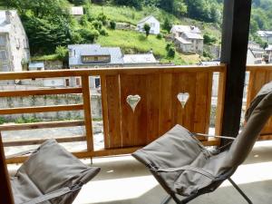 a pair of chairs sitting on a balcony with a view at Boost Your Immo Bois De Marie Barèges PM9 in Barèges