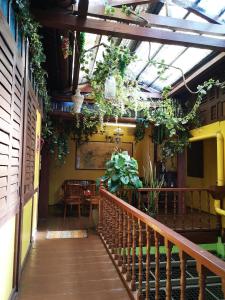a room with a balcony with plants and a table at Vintage House in George Town