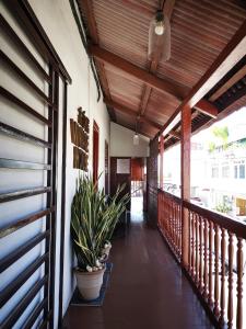 a porch of a house with plants on it at Vintage House in George Town