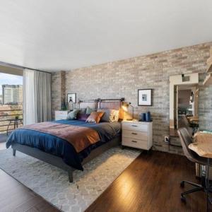 a bedroom with a bed and a brick wall at Panorama Place in Reno