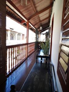 a wooden porch with a bench on a balcony at Vintage House in George Town