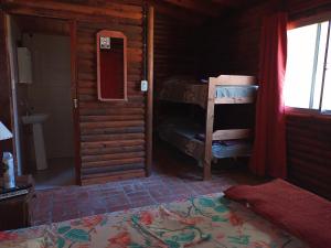 a room with a bedroom with a bed and a window at Complejo Sagitario in Gualeguaychú
