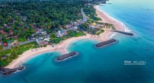 an aerial view of a beach with rocks in the water at Sea Yo Villa - Hikkaduwa in Hikkaduwa