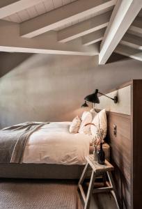 a bedroom with a bed and a table with a lamp at Nomad by CERVO Mountain Resort in Zermatt