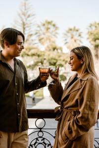 a man and a woman are holding drinks at Plaza Central in Arequipa