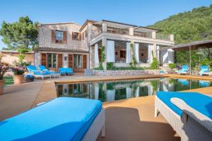 a home with a swimming pool and a house at Villa Rafam - Deia in Deia