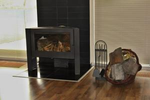 a living room with a fireplace in a room at Private holiday house Vivendi in Liptovský Mikuláš