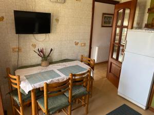 a dining room with a table and a refrigerator at CASA DEL ARROYO in Pontevedra