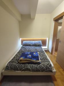 a bedroom with a bed with a blanket on it at Suncani apartman 36, Brzece in Brzeće