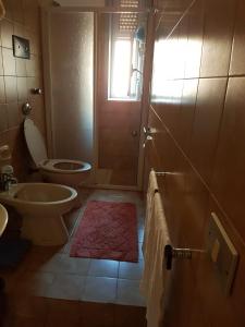 a bathroom with a toilet and a sink and a shower at Da mare e d'amore in Spadafora