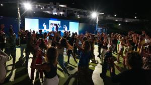 a crowd of people dancing on a stage at a concert at Villaggio Residence Bahja in Paola