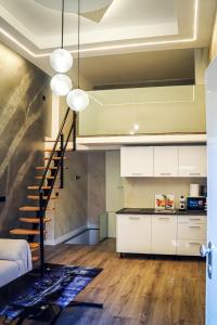 a kitchen with a staircase and a living room at Tofi 2 in Madrid