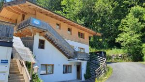 a house with a staircase on the side of it at Haus Carina in Kirchberg in Tirol