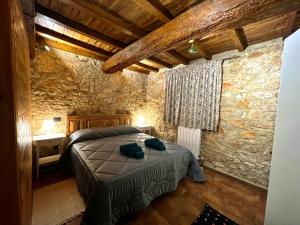 a bedroom with a bed and a stone wall at B&B Fontanelle in Alviano