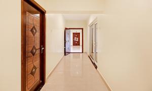an empty corridor with a door and a hallway at Treebo Aall Season in Kodaikānāl