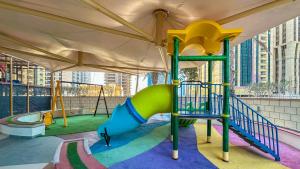 a playground with a slide in a building at Scenic High Floor 1BR at Ocean Heights, Dubai Marina by Maxx Value Homes in Dubai