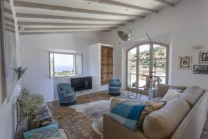a living room with a couch and a tv at Casa Berne - Deia in Deia