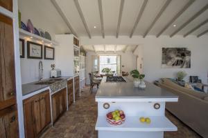 a kitchen and living room with a bowl of fruit at Casa Berne - Deia in Deia